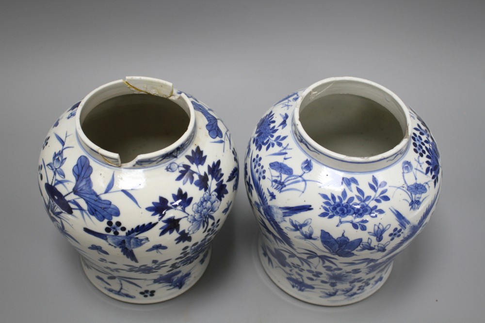 A pair of 19th century Chinese blue and white vases and covers, decorated with birds and flowers, height 23cm